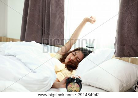 Cute Asia Woman Wake Up With Stretch Oneself And Put Off The Alarm To Turn Off Alarm Clock