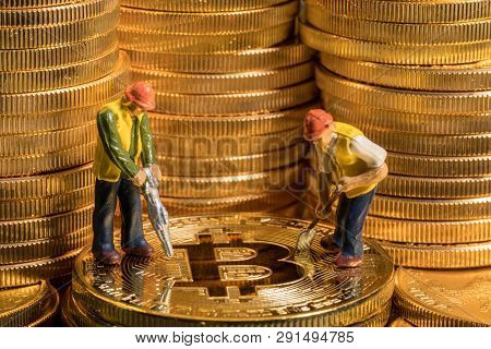 Concept Illustration Of Two Miners Mining New Bit-coin Cybercurrency Virtual Coins In The Blockchain