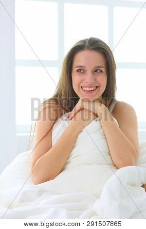 Young Caucasian Woman Covering Her Head And Ears With Pillows