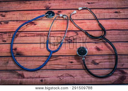 Two Stethoscopes With Diaphragms On Wood Table