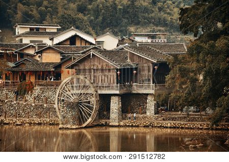FUJIAN, CHINA â MARCH 2, 2018: Yunshuiyao old town by the river with watermill in Fujian, China.