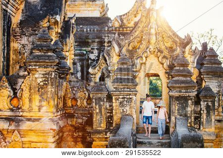 Kids brother and sister visiting ancient Maha Aung Mye Bonzan Monastery one of the most beautiful landmarks of Royal City of Inwa in Myanmar