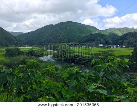 Beautiful View Of The Typical Japanese Countryside With Mountains And Rice Paddies. This Is Located 