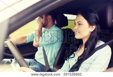 leisure, road trip, travel and people concept - woman driving car and man covering face with his palm