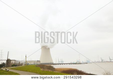 May 2016, Doel, Antwerp, Belgium, Cooling Towers Of The Nucleair Power Plant In Doel Next To The Riv