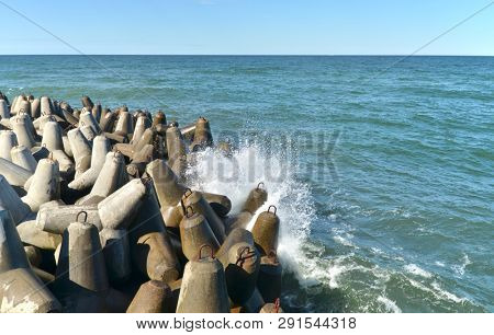 Protection of the coast made of concrete heavy brakewater elements.
