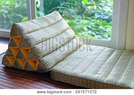 Triangle Backrest Pillow And Folding Mattress Prepared Closed To Window Exit Of Living Room To The O