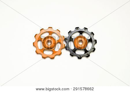 Black And Golden Rollers, Gear For Bicycle Rear Derailleur Isolated On White Background