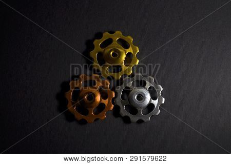 Color Rollers, Black, Golden, Orange Gears For Bicycle Rear Derailleur On Black Color In Shape Of Tr
