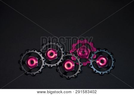 Color Rollers, Black, Purple Gears For Bicycle Rear Derailleur On Black Background In Bottom Side, W