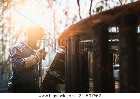 Industrial Welder Welding Fabricated Construction In Factory, Welding Process By Shielded Metal Arc 