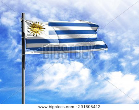 National Flag Of Uruguay On A Flagpole In Front Of Blue Sky.