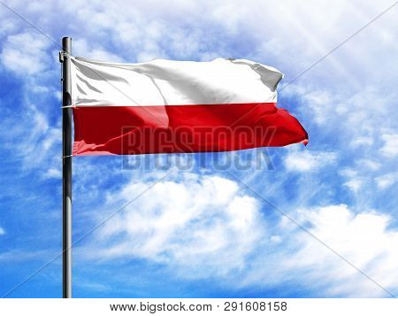 National Flag Of Poland On A Flagpole In Front Of Blue Sky.