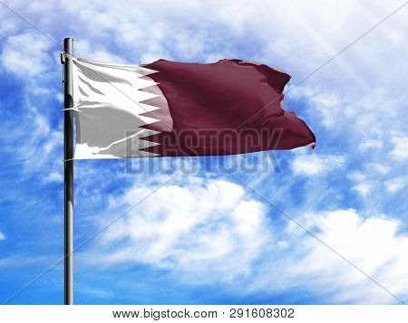 National Flag Of Qatar On A Flagpole In Front Of Blue Sky.