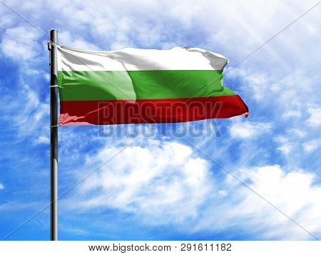National Flag Of Bulgaria On A Flagpole In Front Of Blue Sky.