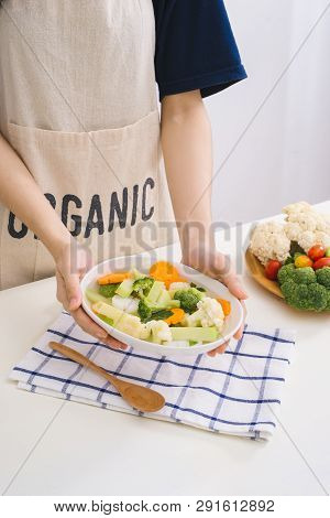 Fresh Vetgetables,carrots,long Beans, Boiled Corn In Hand On White Table