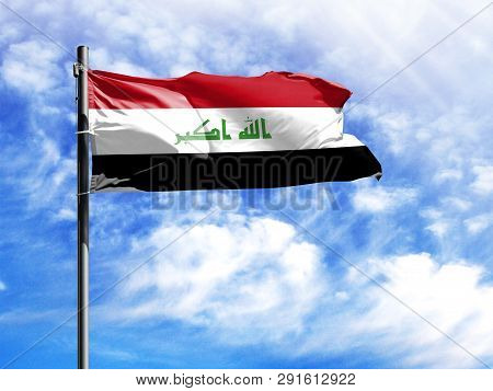 National Flag Of Iraq On A Flagpole In Front Of Blue Sky.