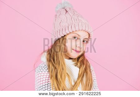 Child Long Hair Warm Soft Woolen Hat Enjoy Softness. Kid Girl Wear Knitted Soft Hat Pink Background.