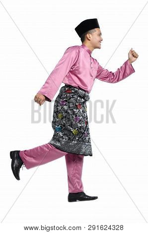 Portrait Of Young And Handsome Asian Man With Traditional Clothing During Hari Raya Over White Backg