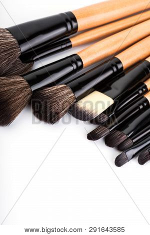 Various Makeup Brushes Isolated Over White. Wooden Makeup Brushes. Duo Fibre Foundation Makeup Brush