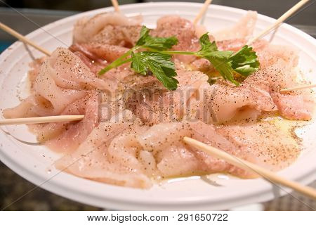 A Delicious Carpaccio Of Fresh Mediterranean Swordfish, Seasoned With Extra Virgin Olive Oil, Parsle
