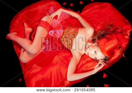 Sexy Burlesque Dancer Stripper Posing With Sweet Lollipop, In Red Corset And Red Hat With Curly Hair