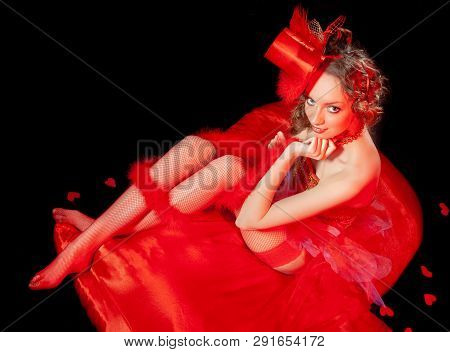 Sexy Burlesque Dancer Stripper Posing With Sweet Lollipop, In Red Corset And Red Hat With Curly Hair