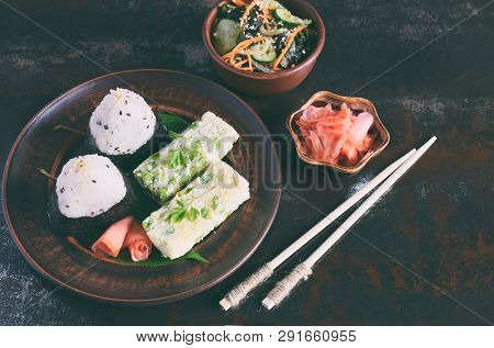 Mix Of Japanese Food - Rice Balls Onigiri, Omelette, Pickled Ginger, Sunomono Wakame Cucumber Salad