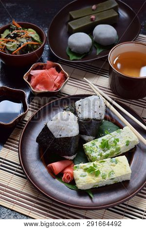 Mix Of Japanese Food - Rice Balls Onigiri, Omelette, Ginger, Sunomono Wakame Cucumber Salad. Traditi