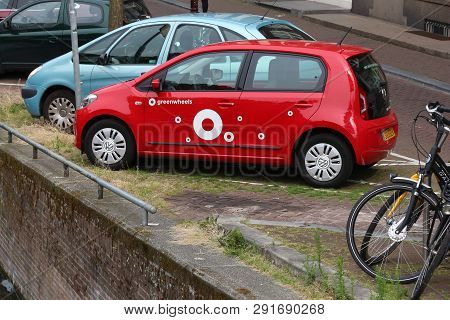 Amsterdam, Netherlands - July 10, 2017: Greenwheels Car Sharing Vehicle Vw Up Parked By The Canal In