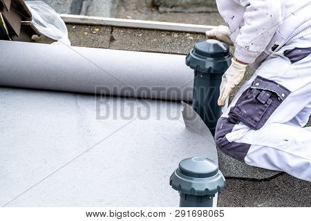 Construction Worker Using Tarpaulin As Covering Sheet To Protect The Ground