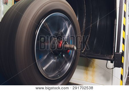 Repairman Balances The Wheel And Installs The Tubeless Tire Of The Car On The Balancer In The Worksh