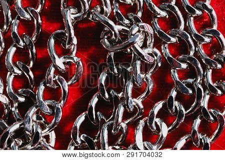 Jewelry On A Red Velvet Background. Silver Chain.vintage Background.