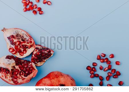Garnet Background. Ripe Red Garnet Fruit. Garnet Fruit Slices On A Blue Background. Vegetarian Conce