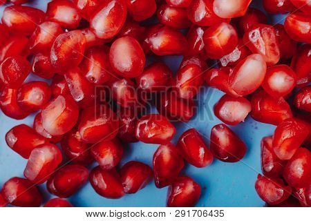 Garnet Background. Ripe Red Garnet Fruit. Garnet Fruit Slices On A Blue Background. Vegetarian Conce