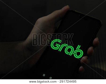 KUALA LUMPUR, MALAYSIA - march 24, 2019 : grab car apps and green taxi toy car, Grab Car, high demand for public transport in Malaysia.