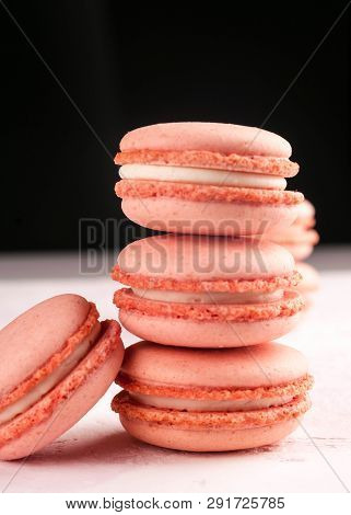 Pink Stacks With Macarons Dessert On White Texutured Background Isolated On Black