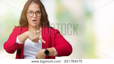 Beautiful plus size young business woman wearing elegant jacket and glasses over isolated background In hurry pointing to watch time, impatience, upset and angry for deadline delay