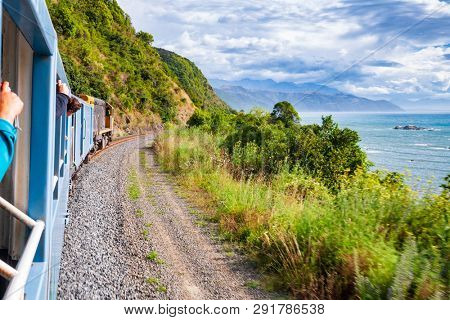 Scenic train ride along Pacific ocean coast in Canterbury regoin, South Island of New Zealand