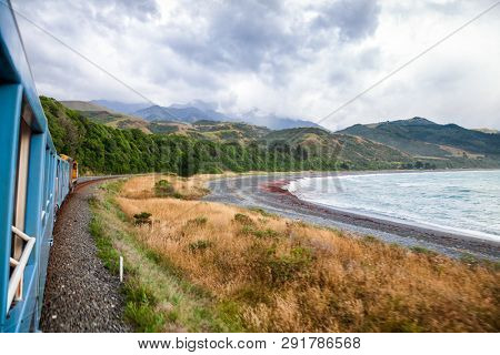 Scenic train ride along Pacific ocean coast in Canterbury regoin, South Island of New Zealand