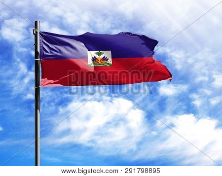 National Flag Of Haiti On A Flagpole In Front Of Blue Sky.
