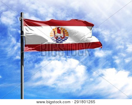 National Flag Of French Polynesia On A Flagpole In Front Of Blue Sky.
