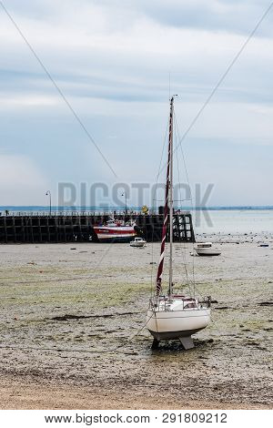 Cancale, France - July 27, 2018: The Harbour Of Cancale At Low Tide A Cloudy Day Of Summer, French B
