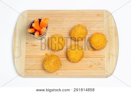 Breaded Chicken Ball On A Wooden Carrot