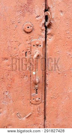 Old Door Handle Red Texture. Vintage Retro Demage Doors