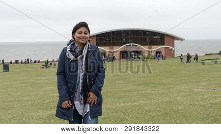 A Young Lady Enjoying The Seafront, The Pier And The Green At Hunstanton In Norfolk, Uk