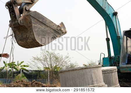 Excavator Backhoe Tractor Putting Pipe On Ground At Construction Site