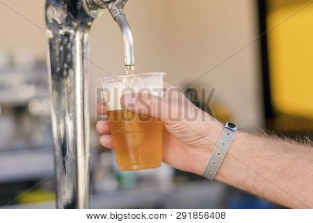 Man Pouring Fresh Beer In Self Service Bar - With All Inclusive Badge