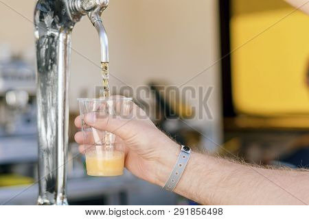 Man Pouring Fresh Beer In Self Service Bar - With All Inclusive Badge