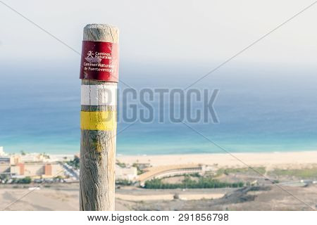 Post On The Fuerteventura Mountains Informing Hikers About The Trail. Sign Says: Natural Trail. Natu